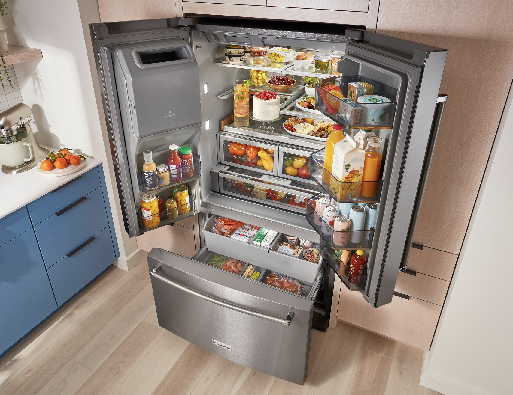 a full kitchen aid refrigerator with all the doors and drawers open